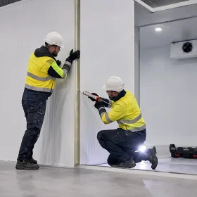 HVAC-R technicians installing PIR insulated panels in a new UK cold room.